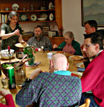 People sitting down to lunch around big circular table