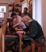 Residents work in the weaving shop