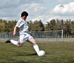 player kicking soccer ball