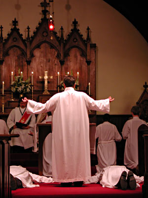 
Part of the ordination service required the new priests to lie prostrate on the ground, while the new ministers knelt at the front of the sanctuary. (MPR Photo/Jeff Horwich)