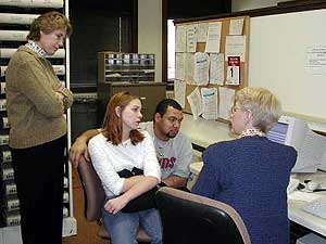 
Joanne Fay listens as Michelle and Eric Romero find tax records on the house they want to buy.

 (MPR Photo/Stephanie Hemphill)