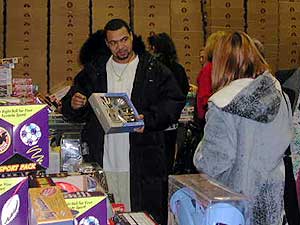 
Michelle and Eric Romero choose Christmas presents for their sons at the Salvation Army.

 (MPR Photo/Stephanie Hemphill)