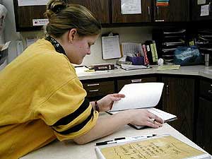 
Rhonna spends part of her work day "charting," recording her impressions of the behavior of the kids she works with. Rhonna works at a residential drug treatment program for teenagers.
 
 (MPR Photo/Chris Julin)