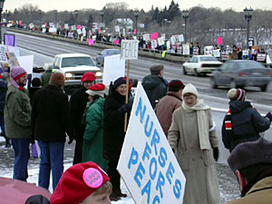 
About 1,000 anti-war protesters slowed traffic Wednesday night  as they lined the Lake Street bridge over the Mississippi River.  (MPR Photo/Marisa Helms)
