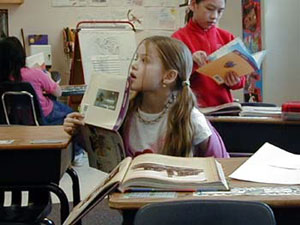 
Mina Krenz is already ahead of her third grade classmates on their reading assignment. (MPR Photo/Tim Pugmire)