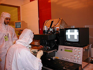 
Graduate students use a high-powered microscope at the University of Minnesota's nanotechnology lab.  It's the only nanotech laboratory in the state. (MPR Photo/Erin Galbally)