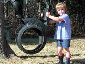 
Four-year old Kyra Peterson in her back yard. Kyra's mother won't let Kyra play outside alone. Kyra recently stepped in a bear's "calling card" in the back yard. (MPR Photo/Chris Julin)