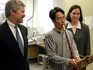 
Hartwick and McCollum listen as Meng Veng plays a Laotian mouth harp called a Queej. (MPR Photo/Art Hughes)