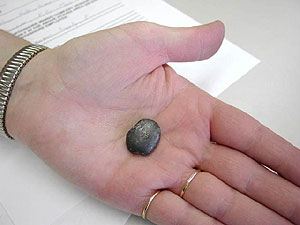 
Ore travels through a furnace hotter than 2500 degrees Fahrenheit.  The heat drives out oxygen and other impurities, and melts the ore into nuggets the size of a small marble.  (MPR Photo/Stephanie Hemphill)