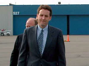 
Gov. Pawlenty walks toward the state airplane at St. Paul's Holman Field on Monday. The governor was beginning an around-the-state tour to tout highlights of the legislative session. (MPR Photo/Mark Zdechlik)