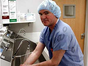 
Park Rapids surgeon Dr. Daniel Smith prepares to perform a gastric bypass operation. Smith does about 10 of the procedures each week at St. Joseph's hospital. St. Joseph's will soon build an entire wing for gastric bypass patients. (MPR Photo/Tom Robertson)