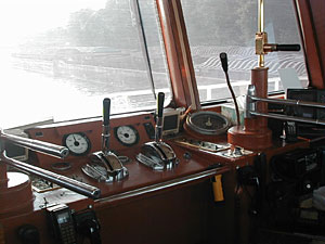 
This is Cecil Jackson's steering column.  Long silver poles help steer the boat, and the brakes are in the center of the board.  Radar monitors are on both sides of the steering column.  They are especially useful at night, showing outlines of islands and open river.

 (MPR Photo/Erin Galbally)