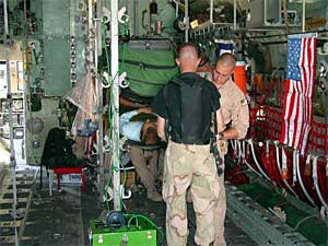 
Senior Airman Will Stuller (front) and Staff Sgt. Kevin Fries congigure C-130 aircraft for the transfer of injured soldiers out of Baghdad. (Photo/Maj. Gene Delaune)