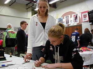 
Freshman Ashley Wehri, seated, works on ribbons in an art class at Rocori. The ribbons are tributes to the victoms.
 (MPR Photo/Jeff Horwich)