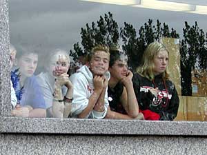 
Some Rocori Junior High School students watch the
funeral procession from their classroom window.  The school is immediately next door to St. Boniface Church.
 (MPR Photo/Annie Baxter)