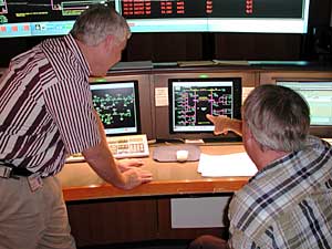 
Xcel's Transmission Control Center in Minneapolis is responsible for managing transmission for 1.3 million Xcel customers. Video screens monitoring Xcel's power plants cover the walls of the center. Engineers work around the clock monitoring the transmission grid. (MPR Photo/Rob Schmitz)