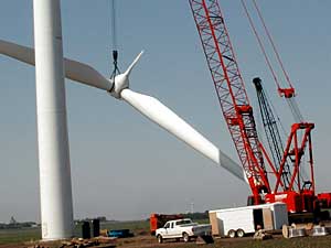 
A crane lifts the blades in place for the Feys' wind 
turbine. The Feys own two wind machines. Each costs
roughly $1 million. (MPR Photo/Mark Steil)