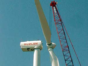 
A crane lifts the final piece into place, completing
a wind turbine owned by Doug and Pam Fey.   (MPR Photo/Mark Steil)