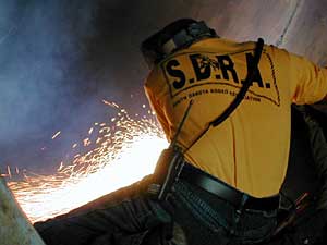 
A welder inside a wind tower being built at SMI &  
Hydraulics in Porter, Minnesota. The steel towers are more
than 200 feet tall. (MPR Photo/Mark Steil)