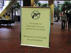 
This sign banning guns in the county building is virtually the only sign of security in the center. (MPR Photo/Elizabeth Stawicki)
