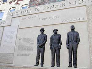 
Elmer Jackson, Elias Clayton and Isaac McGhie are portrayed in bronze on the corner where they died.  (MPR photo/Chris Julin)