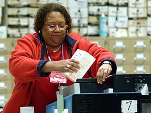
An elections board worker places ballots in a card reading machine to count the votes Tuesday night in Cleveland, Ohio. The outcome of the presidential race hinges on the final vote count in Ohio.  (Photo by Michael Williams/Getty Images)