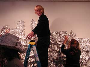 
The volunteers quickly covered the walls with sheets of tin foil. (MPR photo/Annie Baxter)