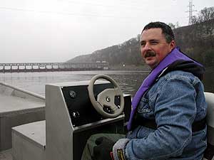 
DNR Fisheries Specialist Kevin Stoffer drives a boat on the Mississippi River near Hastings, almost 60 miles upstream where an Asian carp was caught. (MPR Photo/Rob Schmitz)
