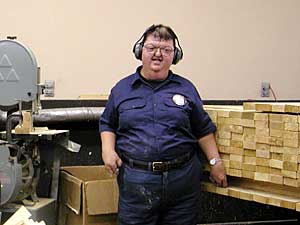 
Ron runs the main saw in the sawshop at West Central Industries.  He's been employed by the organization for 25 years. (MPR Photo/Annie Baxter)