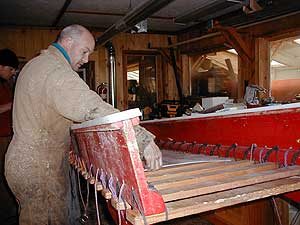 
Team member Paul Pregont works on one of the three sleds which the six-member team will take on its 3,000-mile trek. (MPR Photo/Bob Kelleher)