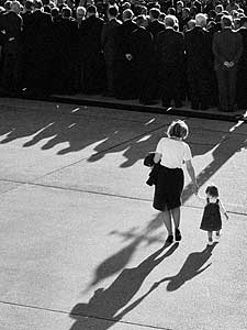 
Senator Kay Bailey Hutchison walks her daughter toward a Senate event. Photographer Melina Mara says she was attracted to the image of a lone woman up against a wall of men. (Photo/Melina Mara)