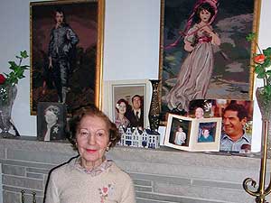 
Pianist Beatrice Ohanessian moved to the United States with her sister to be closer to their brother. She stands before a fireplace mantle filled with photos of her parents and siblings. (MPR Photo/Marianne Combs)