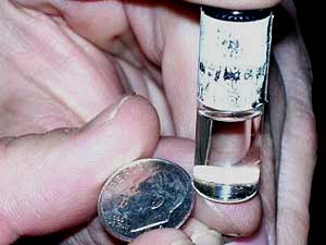 
This vial contains hundreds of computer chips that are being
used to develop sensors for military and commercial uses.  (MPR photo/Dan Gunderson)