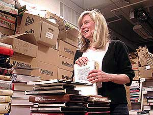 
Jane Fleeson helps organize books for the Duluth Public Library book sale.  She checks the internet to find out how much the rarer books are worth.  Charging slightly higher prices for the more valuable books brings in more money for the library. (MPR Photo/Stephanie Hemphill)