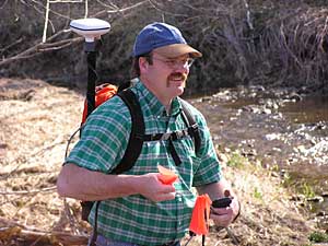 
Natural Resources Conservation Service technician Mike Henderson surveys the stream using a Global Positioning Satellite device.
 (MPR Photo/Lorna Benson)