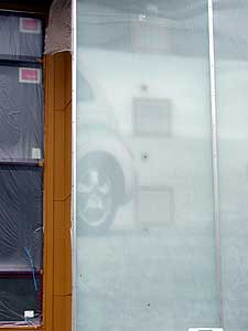 
The use of polycarbonate on the exterior allows for light to filter through certain parts of the building. It also exposes the internal layers of the house, which include pieces of old billboards. (MPR Photo/Marianne Combs)