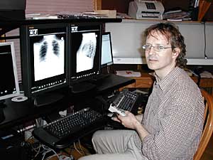 
Bakker's home is linked to a DSL line, and two thin fiber optic lines called T-1s. He pays several thousand dollars for Internet speeds that can handle large amounts of data. Bakker can view and interpret x-rays in a matter of minutes.   (MPR Photo/Tom Robertson)