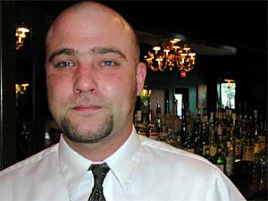 
Times Cafe bartender Nate Kahle says he opposes a smoking ban in bars and restaurants. Even though many ban supporters say it would reduce the health risks of employees in bars, Kahle says it's his choice to work in a place that allows smoking.  (MPR Photo/Marisa Helms)