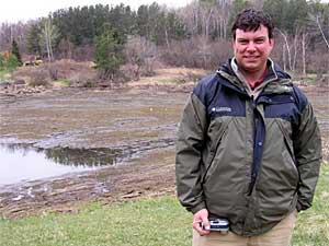 
Doug Jensen is with Minnesota Sea Grant, one of the groups behind the draining of Rock Pond, which is visible in the photo. Jensen says aquarium fish released into the wild can cause a host of problems for native fish. (MPR Photo/Chris Julin)