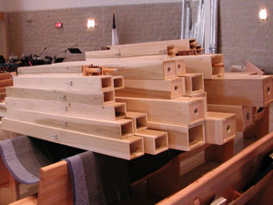 
Organ pipes rest on pews and against walls await assembly (MPR Photo/Valerie Kahler)