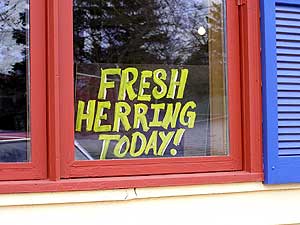 
At the Vanilla Bean Bakery and Cafe, a sign goes in the window when there's fresh herring.  Owner Paul Bergman says it pulls in the customers. (MPR Photo/Stephanie Hemphill)