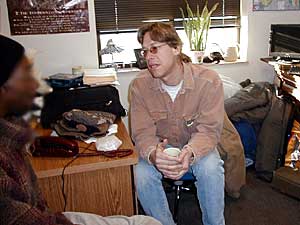 
Brett Byfield offers help to a client who visits him at the Dorothy Day homeless shelter. (MPR Photo/ Lorna Benson)