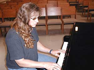 
Some people around Rubetta say this is her most sincere attempt at recovery from meth addiction. Like so many addicts before her, Rubetta has turned to spirituality. She says God saved her life. She now writes Christian songs on the baby grand piano at her church. (MPR Photo/Tom Robertson)