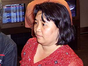 
Chong Thao, before her two sisters and their families arrive at the airport. She had not seen her sisters for 13 years.  (MPR Photo/Toni Randolph)