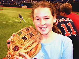 
13-year-old Kelsey Hunstad shows off a glove that was autographed by Joe Mauer.  (MPR Photo/Lorna Benson)