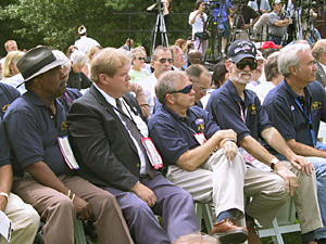
Members of John Kerry's "Band of Brothers" listen to  speakers at a rally to honor veterans. They served with Kerry on a gunboat in Vietnam.

 (MPR Photo/Bob Collins)