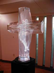 
While many houses of worship have artwork dating back several centuries, they also purchase art from living artists. In this sculpture, an image of Jesus is encased in a glass cross. (MPR Photo/Marianne Combs)