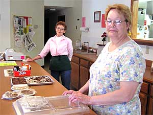
Carole Jordan waits tables at the Vesta Cafe.  Manager Yvonne Ellis leases the building from the community co-op group. (MPR Photo/Annie Baxter)
