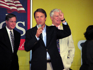 
Flanked by Attorney General Mike Hatch, left, and former Gov. Wendell Anderson, right, Sen. John Edwards speaks to a crowd of about 1,000 people in Rosemount Friday night. (MPR Photo/Mark Zdechlik)