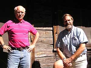 
Chuck Wick, left, and Don Johnson, right. Both are members of the Listening Point Foundation, established to protect Sigurd Olson's lake property, and to preserve Olson's legacy.  Wick and Johnson pose beside Olson's cabin at Listening Point. (MPR Photo/Bob Kelleher)